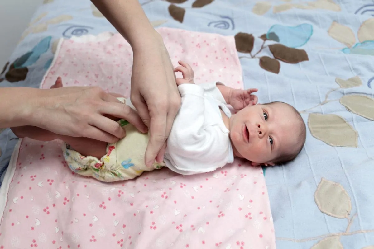 Mutter wechselt Windeln Mutter wechselt Windeln beim Baby